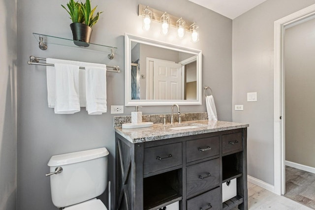 1885 W Greenleaf Ct, Round Lake, IL 60073 - bathroom featuring double vanity, wood finished floors, toilet, and baseboards