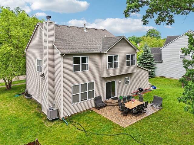 1885 W Greenleaf Ct, Round Lake, IL 60073 - rear view of property featuring a patio, a chimney, central air condition unit, and a lawn