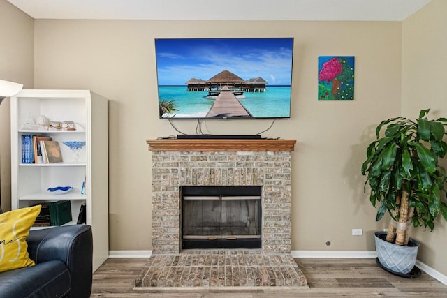 1885 W Greenleaf Ct, Round Lake, IL 60073 - living area with wood finished floors, a brick fireplace, and baseboards