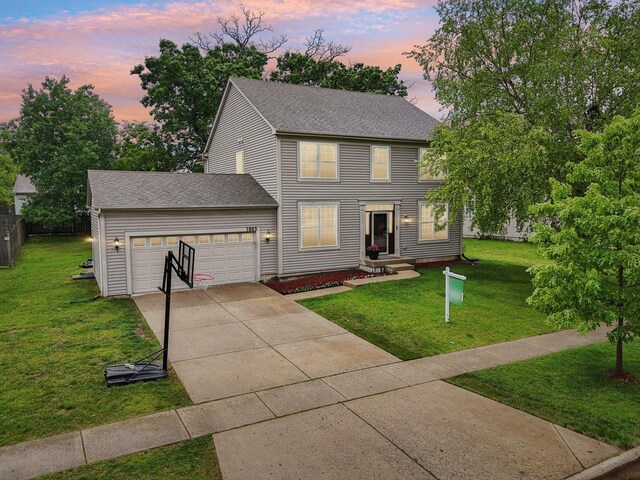 1885 W Greenleaf Ct, Round Lake, IL 60073 - colonial house with concrete driveway, a garage, and a shingled roof