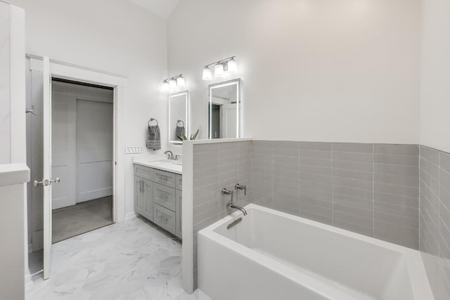 2722 N Bosworth Ave, Chicago, IL 60614 - bathroom featuring vanity, a garden tub, and marble look tiles