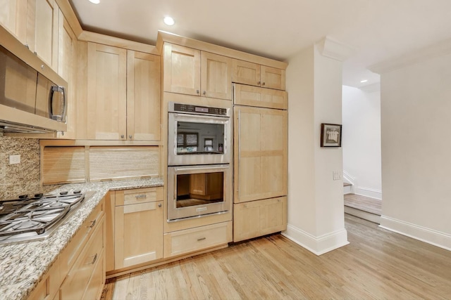 2722 N Bosworth Ave, Chicago, IL 60614 - kitchen featuring light brown cabinetry, stainless steel appliances, decorative backsplash, light wood-type flooring, and light stone counters