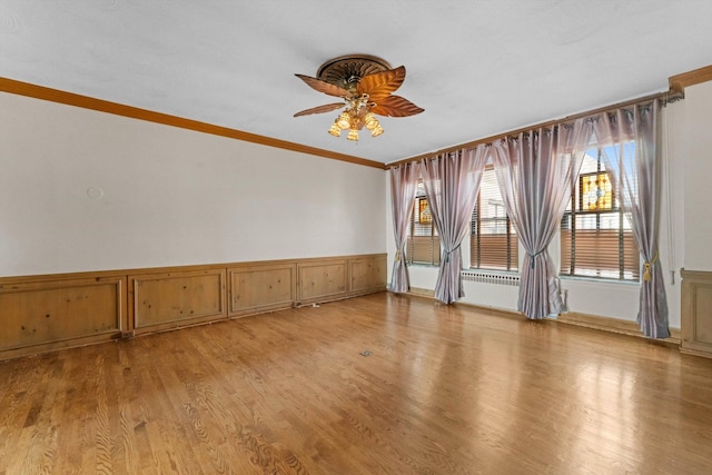 3530 N Lake Shore Dr Unit 12B, Chicago, IL 60657 - spare room featuring ceiling fan, crown molding, wainscoting, and light wood finished floors