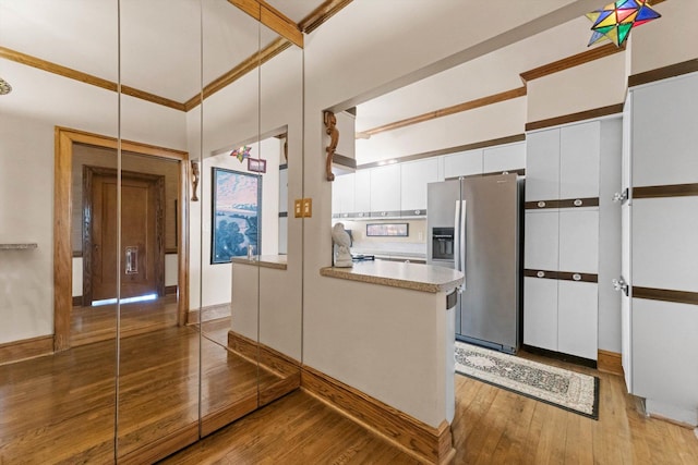 3530 N Lake Shore Dr Unit 12B, Chicago, IL 60657 - kitchen featuring stainless steel refrigerator with ice dispenser, white cabinetry, light wood-style floors, light countertops, and crown molding