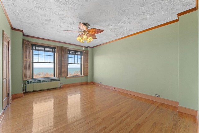 3530 N Lake Shore Dr Unit 12B, Chicago, IL 60657 - empty room featuring radiator, ornamental molding, ceiling fan, light wood-type flooring, and baseboards