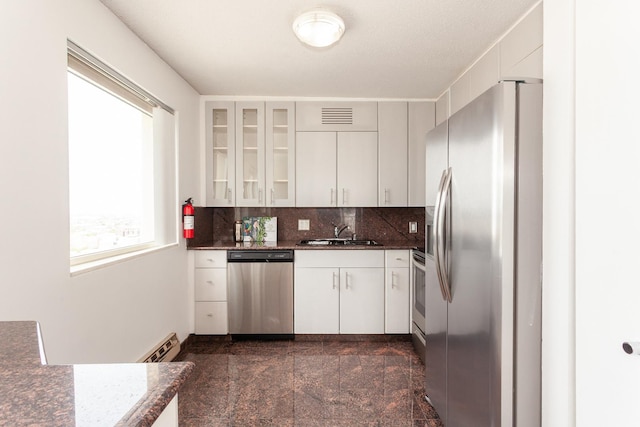 1212 N La Salle Dr Unit 2309, Chicago, IL 60610 - kitchen featuring appliances with stainless steel finishes, granite tiled floors, a sink, glass insert cabinets, and a baseboard heating unit