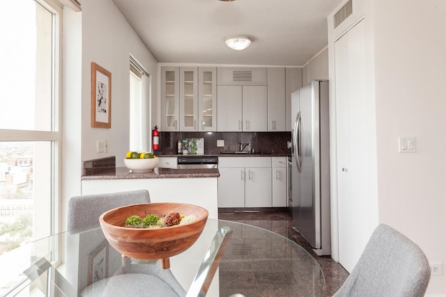 1212 N La Salle Dr Unit 2309, Chicago, IL 60610 - kitchen featuring stainless steel fridge with ice dispenser, a sink, glass insert cabinets, backsplash, and dark countertops