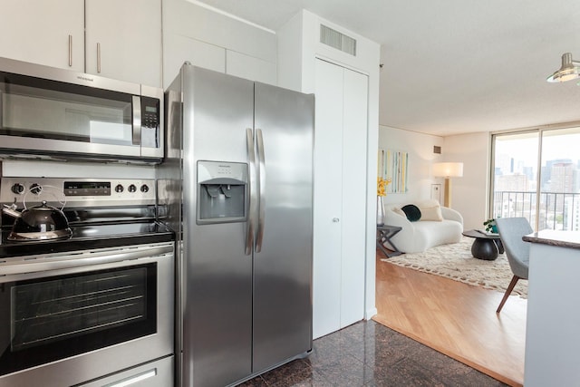 1212 N La Salle Dr Unit 2309, Chicago, IL 60610 - kitchen with stainless steel appliances, granite floors, and white cabinetry
