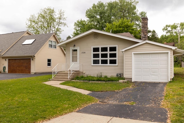 1326 N Harrison St, Algonquin, IL 60102 - view of front facade featuring a front yard, driveway, a chimney, and a garage