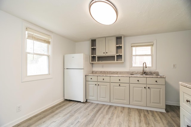1326 N Harrison St, Algonquin, IL 60102 - kitchen featuring freestanding refrigerator, a sink, light wood-type flooring, baseboards, and light countertops