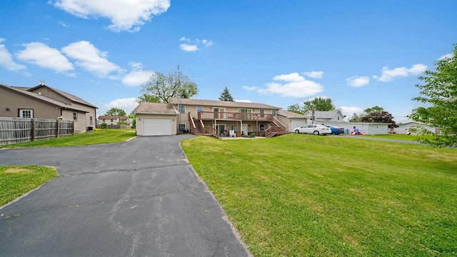 305 S Prairie Ave, Polo, IL 61064 - view of front of home featuring stairway, a deck, asphalt driveway, a residential view, and a garage