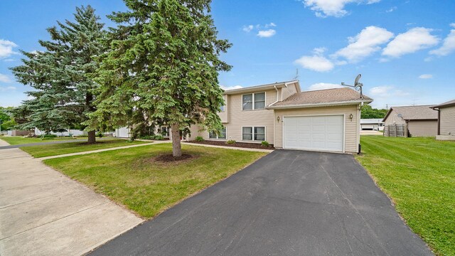 305 S Prairie Ave, Polo, IL 61064 - view of front of house featuring a garage, driveway, and a front yard