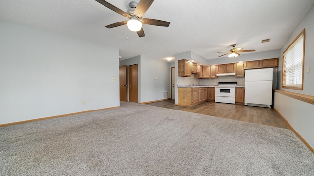 305 S Prairie Ave, Polo, IL 61064 - kitchen featuring white appliances, a ceiling fan, carpet floors, baseboards, and light countertops
