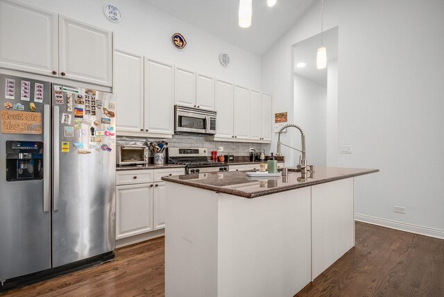 930 W Cuyler Ave Unit 3W, Chicago, IL 60613 - kitchen featuring appliances with stainless steel finishes, dark wood-style floors, white cabinets, decorative backsplash, and high vaulted ceiling