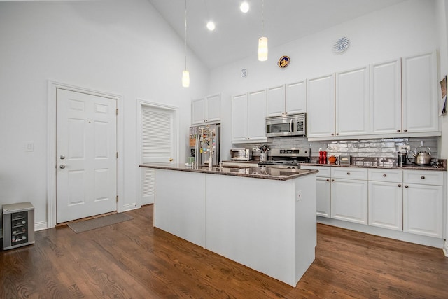 930 W Cuyler Ave Unit 3W, Chicago, IL 60613 - kitchen featuring appliances with stainless steel finishes, high vaulted ceiling, tasteful backsplash, white cabinetry, and hanging light fixtures