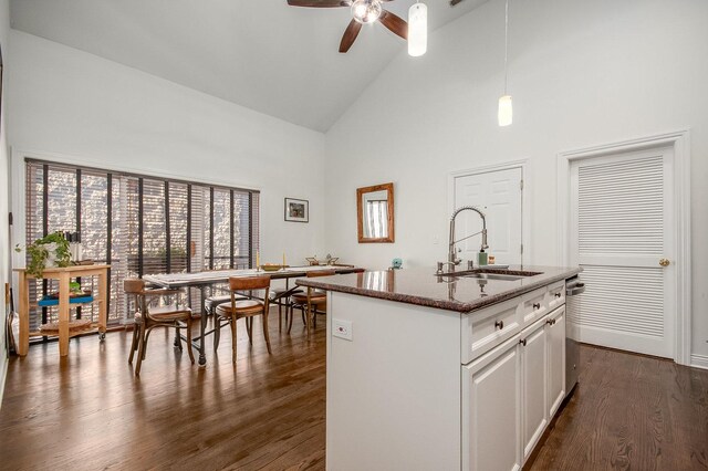 930 W Cuyler Ave Unit 3W, Chicago, IL 60613 - kitchen with high vaulted ceiling, dark wood-style flooring, ceiling fan, dark stone counters, and white cabinets