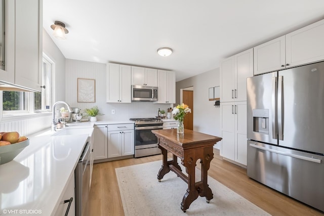 204 Barnwood Trl, Mchenry, IL 60050 - kitchen featuring stainless steel appliances, light wood finished floors, white cabinetry, and light countertops