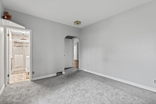 15285 State St, South Holland, IL 60473 - unfurnished bedroom with arched walkways, carpet flooring, baseboards, and ensuite bath