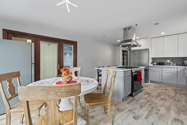 15285 State St, South Holland, IL 60473 - kitchen with stainless steel gas range oven, island exhaust hood, tasteful backsplash, light wood-style floors, and light countertops
