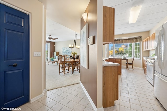 541 N Hough St Unit 205, Barrington, IL 60010 - kitchen featuring white gas stove, light tile patterned floors, a chandelier, pendant lighting, and light countertops