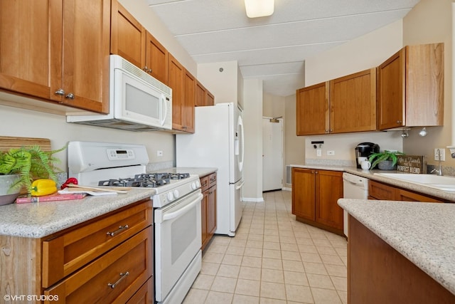 541 N Hough St Unit 205, Barrington, IL 60010 - kitchen with white appliances, light countertops, brown cabinetry, and light tile patterned floors