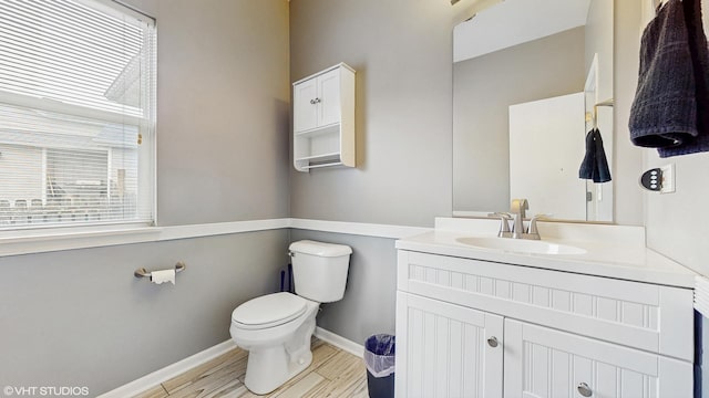 412 Joshua Tree, Harvard, IL 60033 - bathroom featuring toilet, vanity, baseboards, and wood finished floors