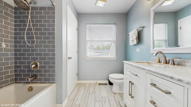 412 Joshua Tree, Harvard, IL 60033 - full bathroom with vanity, plenty of natural light, toilet, and baseboards