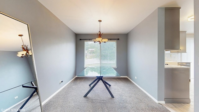 412 Joshua Tree, Harvard, IL 60033 - unfurnished dining area featuring a chandelier, baseboards, and light colored carpet