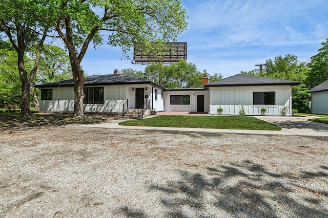 15125 Stoney Island Ave, Dolton, IL 60419 - view of front facade with board and batten siding, entry steps, and a chimney