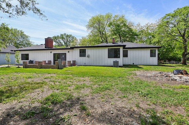 15125 Stoney Island Ave, Dolton, IL 60419 - back of house with board and batten siding, central air condition unit, a chimney, and a yard