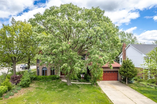 14301 Wooded Path Ln, Orland Park, IL 60462 - view of property hidden behind natural elements with concrete driveway, brick siding, a front yard, and a garage