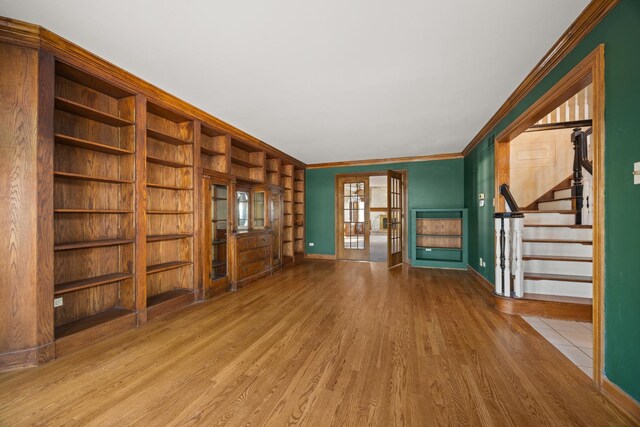 14301 Wooded Path Ln, Orland Park, IL 60462 - unfurnished living room featuring wood finished floors, crown molding, stairway, baseboards, and built in shelves