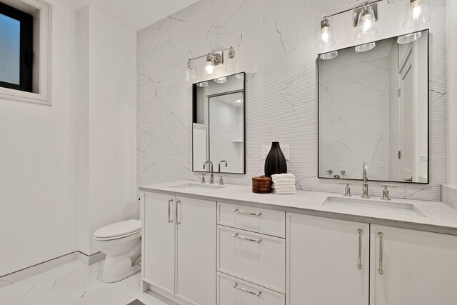 1646 N Orchard St Unit 1N, Chicago, IL 60614 - bathroom with marble look tiles, double vanity, and toilet