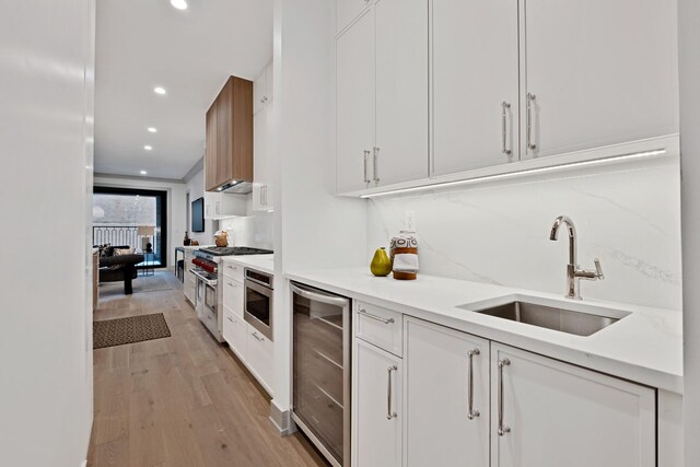 1646 N Orchard St Unit 1N, Chicago, IL 60614 - kitchen with a sink, stainless steel appliances, beverage cooler, white cabinetry, and recessed lighting
