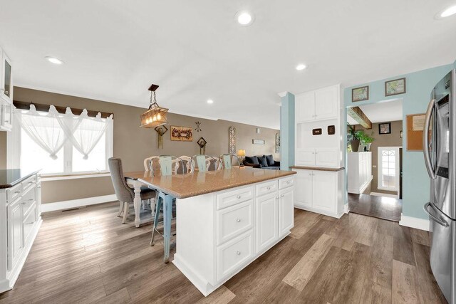 5640 W 82nd Pl, Burbank, IL 60459 - kitchen featuring smart refrigerator, a kitchen breakfast bar, white cabinetry, wood finished floors, and recessed lighting