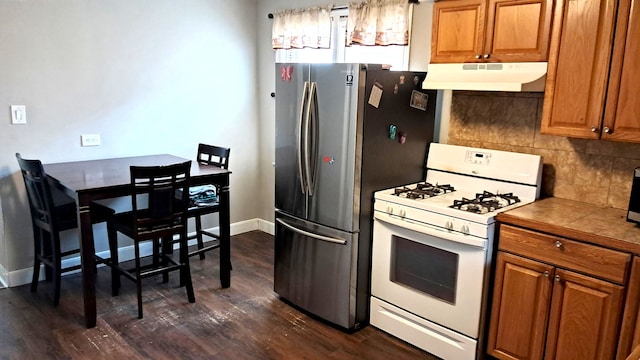 4542 S Lamon Ave, Chicago, IL 60638 - kitchen with gas range gas stove, under cabinet range hood, dark wood finished floors, and brown cabinetry