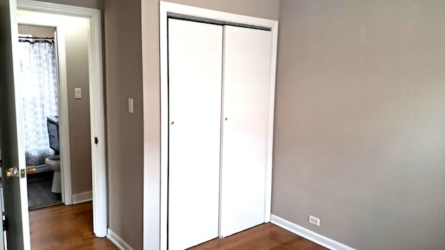 4542 S Lamon Ave, Chicago, IL 60638 - unfurnished bedroom with a closet, baseboards, and dark wood-type flooring