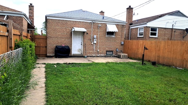 4542 S Lamon Ave, Chicago, IL 60638 - rear view of property featuring brick siding, a patio, roof with shingles, and a chimney