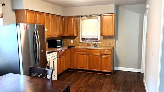 4542 S Lamon Ave, Chicago, IL 60638 - kitchen featuring appliances with stainless steel finishes, a sink, dark wood-style floors, and baseboards