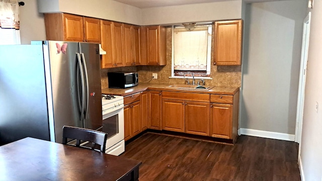 4542 S Lamon Ave, Chicago, IL 60638 - kitchen with a sink, white gas range, freestanding refrigerator, baseboards, and dark wood-style floors