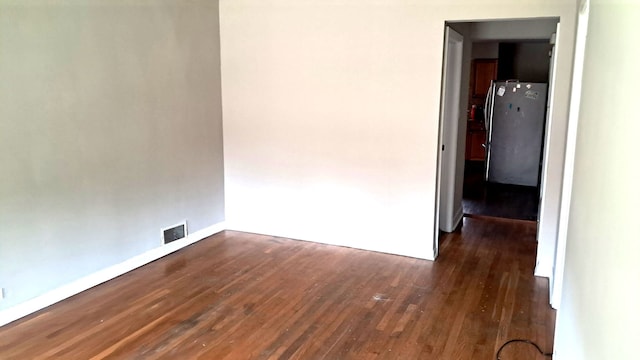 4542 S Lamon Ave, Chicago, IL 60638 - unfurnished room with dark wood-style flooring and baseboards