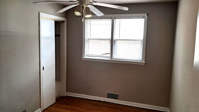 4542 S Lamon Ave, Chicago, IL 60638 - unfurnished bedroom featuring multiple windows, baseboards, dark wood-style flooring, and a closet