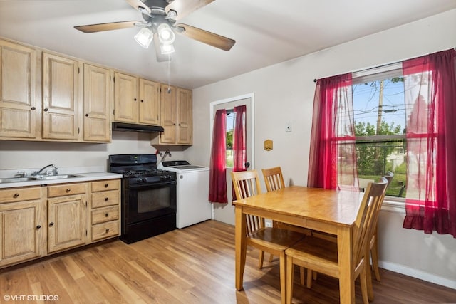 521 Montrose Dr, Romeoville, IL 60446 - kitchen featuring black range with gas stovetop, washer / clothes dryer, under cabinet range hood, a sink, and light brown cabinetry