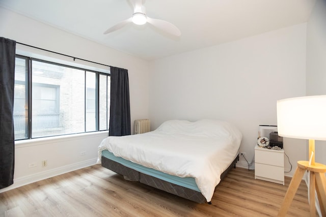 932 W Sunnyside Ave Unit 1C, Chicago, IL 60640 - bedroom with radiator, light wood-style flooring, baseboards, and ceiling fan