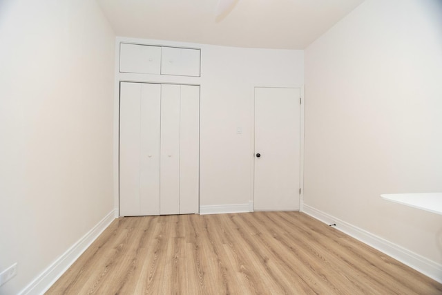 932 W Sunnyside Ave Unit 1C, Chicago, IL 60640 - unfurnished bedroom with light wood-style flooring, baseboards, and a closet