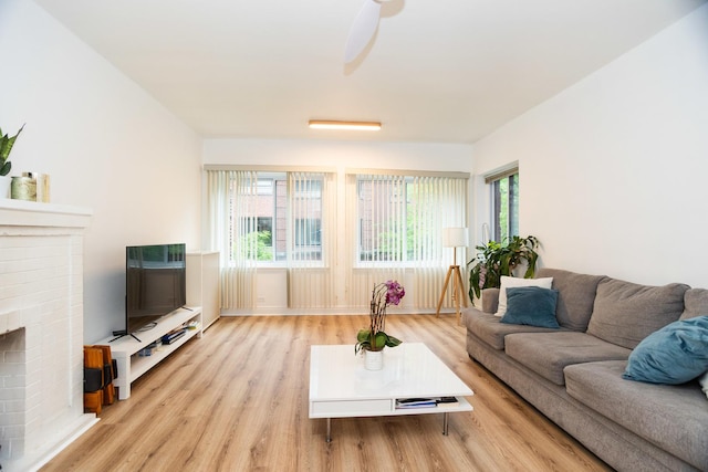 932 W Sunnyside Ave Unit 1C, Chicago, IL 60640 - living room with wood finished floors, plenty of natural light, a fireplace, and a ceiling fan