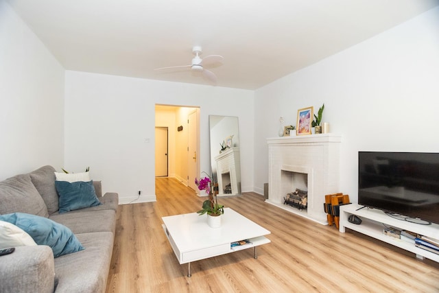 932 W Sunnyside Ave Unit 1C, Chicago, IL 60640 - living area featuring light wood-style floors, a brick fireplace, ceiling fan, and baseboards