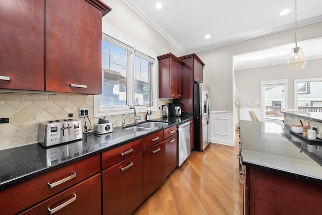 6205 W Grace St, Chicago, IL 60634 - kitchen featuring a sink, stainless steel appliances, light wood-style flooring, ornamental molding, and plenty of natural light