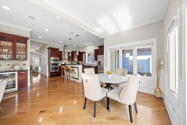 6205 W Grace St, Chicago, IL 60634 - dining area with beverage cooler, crown molding, recessed lighting, and light wood-style floors