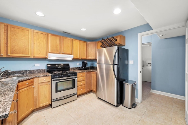 6205 W Grace St, Chicago, IL 60634 - kitchen featuring appliances with stainless steel finishes, under cabinet range hood, a sink, dark stone countertops, and light tile patterned floors